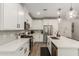 Well-lit kitchen features white cabinets, stainless steel appliances, and modern island at 754 E Harper St # 102, Gilbert, AZ 85297