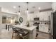 Modern kitchen features white cabinets, stainless appliances, and island with seating at 754 E Harper St # 102, Gilbert, AZ 85297