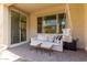 Outdoor seating on the covered patio with a swing and view of the backyard at 754 E Harper St # 102, Gilbert, AZ 85297
