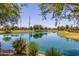 Scenic pond view with lush landscaping and serene blue waters on a sunny day at 754 E Harper St # 102, Gilbert, AZ 85297
