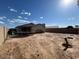 Large backyard features a trampoline, swing set, block wall, and potential for landscaping at 7664 W Vermont Ave, Glendale, AZ 85303