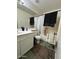 Neutral bathroom featuring a walk-in shower, single sink vanity, and wood-look floors at 7664 W Vermont Ave, Glendale, AZ 85303