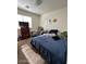 This carpeted bedroom includes a window for natural light and basic furnishings at 7664 W Vermont Ave, Glendale, AZ 85303