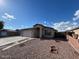 Charming single-story home with a two-car garage, desert landscaping, and a welcoming entryway at 7664 W Vermont Ave, Glendale, AZ 85303