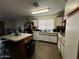 The spacious kitchen features an island, white cabinets, and vinyl floors at 7664 W Vermont Ave, Glendale, AZ 85303