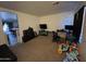 The room is carpeted, with an open doorway into the kitchen, bright interior, and plenty of space at 7664 W Vermont Ave, Glendale, AZ 85303