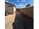 Side yard with block wall, air conditioning units, and a blank slate for landscaping at 7664 W Vermont Ave, Glendale, AZ 85303