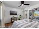 Bright bedroom with modern decor, ceiling fan and a gray patterned rug at 8317 E Orange Blossom Ln, Scottsdale, AZ 85250
