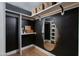 Modern walk-in closet with shelves and a mirrored display niche at 8317 E Orange Blossom Ln, Scottsdale, AZ 85250