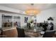 Dining area with modern chandelier and open patio access at 8317 E Orange Blossom Ln, Scottsdale, AZ 85250