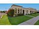 Lovely front exterior with vibrant bougainvillea, arched windows, and neatly trimmed lawn at 8317 E Orange Blossom Ln, Scottsdale, AZ 85250