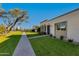 Manicured lawn and mature tree in a residential community at 8317 E Orange Blossom Ln, Scottsdale, AZ 85250