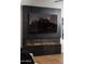 Sleek black tiled fireplace with glass front at 8317 E Orange Blossom Ln, Scottsdale, AZ 85250
