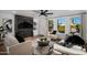 Modern living room with sleek fireplace, large windows, and contemporary furnishings at 8317 E Orange Blossom Ln, Scottsdale, AZ 85250