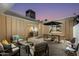 Covered patio boasts comfortable seating and dining areas for outdoor living at 8317 E Orange Blossom Ln, Scottsdale, AZ 85250