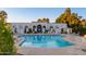 Community pool surrounded by lounge chairs and shade umbrellas at 8317 E Orange Blossom Ln, Scottsdale, AZ 85250