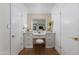 Bright vanity area between closets with soft lighting and decor at 8317 E Orange Blossom Ln, Scottsdale, AZ 85250