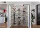 Modern wine rack with stone backsplash and wine display at 8317 E Orange Blossom Ln, Scottsdale, AZ 85250