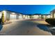 Circular driveway leading to a home with multiple garages, landscaping and desert plants at 9045 E Chino Dr, Scottsdale, AZ 85255