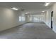 Expansive, well-lit empty room offering versatile space with concrete floors and multiple windows at 9045 E Chino Dr, Scottsdale, AZ 85255