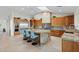 Gourmet kitchen boasts custom cabinets, granite countertops, stainless steel appliances, and a spacious center island with seating at 9045 E Chino Dr, Scottsdale, AZ 85255
