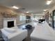 Bright living room with fireplace, piano, and white furniture at 9045 E Chino Dr, Scottsdale, AZ 85255
