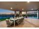 Outdoor patio with dining area, fireplace, and views of the desert and pool at 9045 E Chino Dr, Scottsdale, AZ 85255