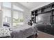 Bedroom featuring large windows and a built-in shelving unit with a tv at 939 E Paseo Way, Phoenix, AZ 85042