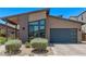 Contemporary single-Gathering home featuring desert landscaping, modern window design, and a convenient two-car garage at 939 E Paseo Way, Phoenix, AZ 85042