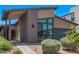 Modern home with a covered entryway, desert landscaping, and beautiful windows at 939 E Paseo Way, Phoenix, AZ 85042