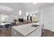 Open floor plan boasts kitchen with seating area and living room with hardwood floors at 939 E Paseo Way, Phoenix, AZ 85042