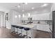 Modern kitchen with white cabinets, granite countertops, stainless steel appliances and island seating at 939 E Paseo Way, Phoenix, AZ 85042