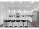 Modern kitchen with white cabinets, granite countertops, stainless steel appliances and counter seating at 939 E Paseo Way, Phoenix, AZ 85042