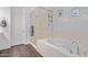 Clean, bright main bathroom with a large soaking tub and a walk-in shower at 939 E Paseo Way, Phoenix, AZ 85042