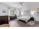 Bright main bedroom features a ceiling fan, hardwood floors, and neutral decor at 939 E Paseo Way, Phoenix, AZ 85042