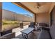Relaxing covered patio with a ceiling fan and patio furniture, creating a comfortable outdoor space at 939 E Paseo Way, Phoenix, AZ 85042