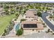 An aerial perspective of a desert community, showcasing a home's private pool, desert landscaping, and solar panels at 9722 S 45Th Ave, Laveen, AZ 85339