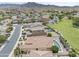 Aerial view showcases a desert community with landscaped yards and a home featuring a refreshing backyard pool at 9722 S 45Th Ave, Laveen, AZ 85339