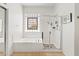 Bathroom featuring a soaking tub, shower, and custom window at 9722 S 45Th Ave, Laveen, AZ 85339