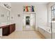 Bathroom featuring a soaking tub, shower, and mirrored closet with a large mirror at 9722 S 45Th Ave, Laveen, AZ 85339