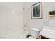 Clean white bathroom with framed artwork, offering a serene and functional space at 9722 S 45Th Ave, Laveen, AZ 85339