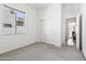 A clean and simple bedroom featuring a double door closet and an empty space for furniture at 9722 S 45Th Ave, Laveen, AZ 85339