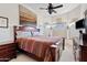 Bedroom featuring a large bed with decorative pillows, art, and a ceiling fan at 9722 S 45Th Ave, Laveen, AZ 85339