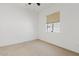 Neutral bedroom features a window with natural light and carpeted floors for comfort at 9722 S 45Th Ave, Laveen, AZ 85339