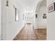 Inviting hallway with decorative tile flooring leading to the front door and arched doorways at 9722 S 45Th Ave, Laveen, AZ 85339