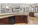 Open kitchen featuring a dishwasher, tiled flooring, and views of the living area at 9722 S 45Th Ave, Laveen, AZ 85339