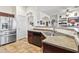 Spacious kitchen with a stainless steel refrigerator, sink, and tiled floors at 9722 S 45Th Ave, Laveen, AZ 85339