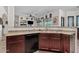 Functional kitchen featuring dark cabinets with convenient eat in bar area at 9722 S 45Th Ave, Laveen, AZ 85339
