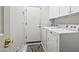 A laundry room featuring white appliances, a white door, and neutral wall paint at 9722 S 45Th Ave, Laveen, AZ 85339