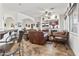 Open-concept living room with bar seating and a cozy fireplace and comfortable leather furniture at 9722 S 45Th Ave, Laveen, AZ 85339